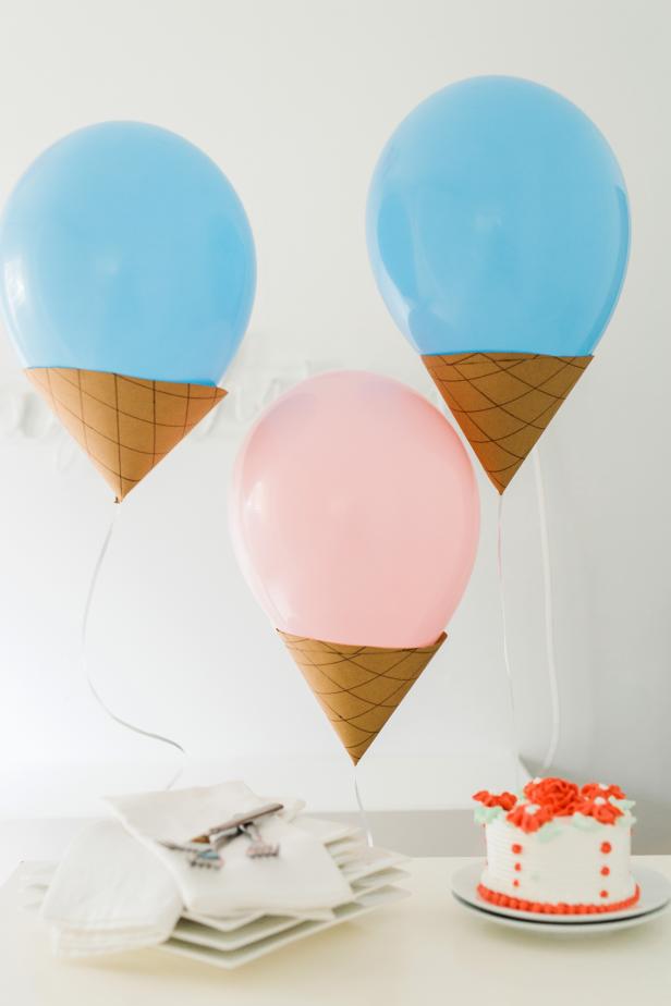 These floating cones are a sweet way to decorate for an ice cream party! You’ll need: latex balloons, a bottle of latex balloon sealant, helium tank, ribbon, scissors, craft knife, brown craft paper, brown wide-tip marker, pencil and double-sided tape.