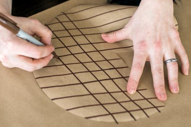 Draw a diamond pattern on the paper with a brown marker. Start out by drawing parallel lines about ½" apart across the brown paper. Then, rotate the paper ¼ of a turn and draw more parallel lines.