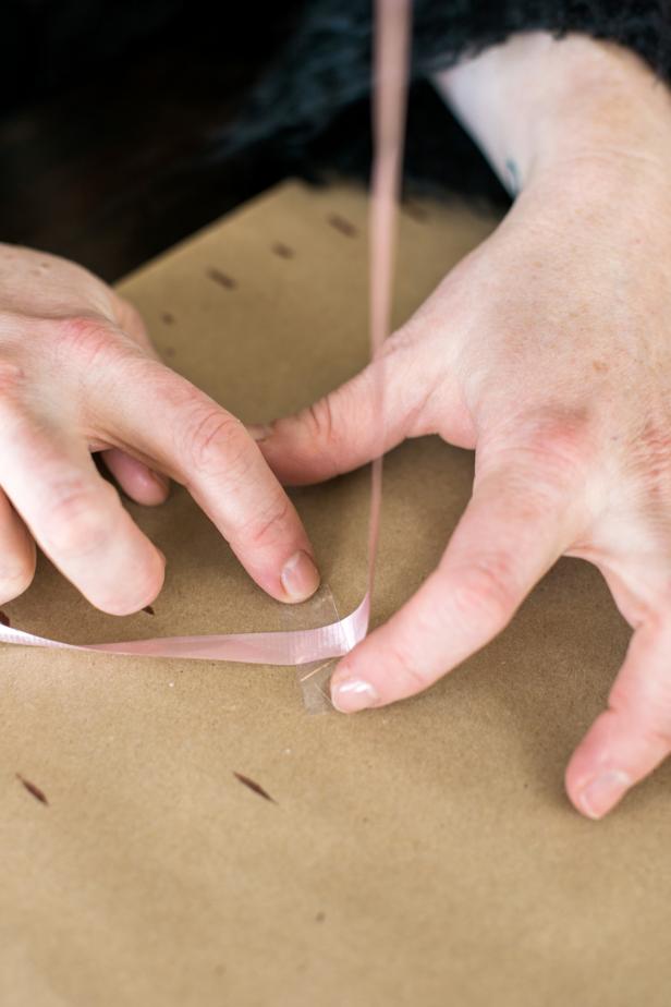 Add latex balloon sealant to an empty balloon per the instructions on the sealant package. Next, fully inflate the balloon with helium. Tie off the balloon and secure with a length of ribbon, taping the ribbon to a flat surface.