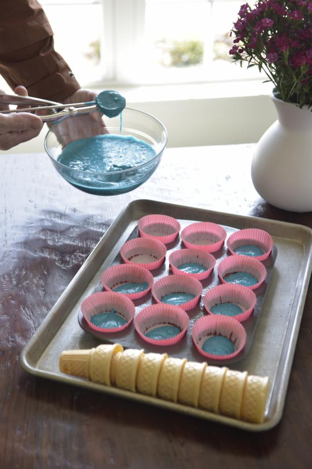 Using an ice cream scoop, fill each paper baking cup 1/3 full with cake mix.