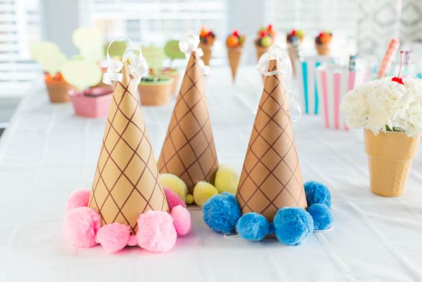 Keep the kids entertained at their next party with this whimsical hat project. You'll need: brown or tan card stock, brown marker, scissors, craft knife, hole punch, hot glue gun and glue sticks, 3/8&quot; width elastic, pom poms in pastel colors, ribbon and a downloadable cone template.
