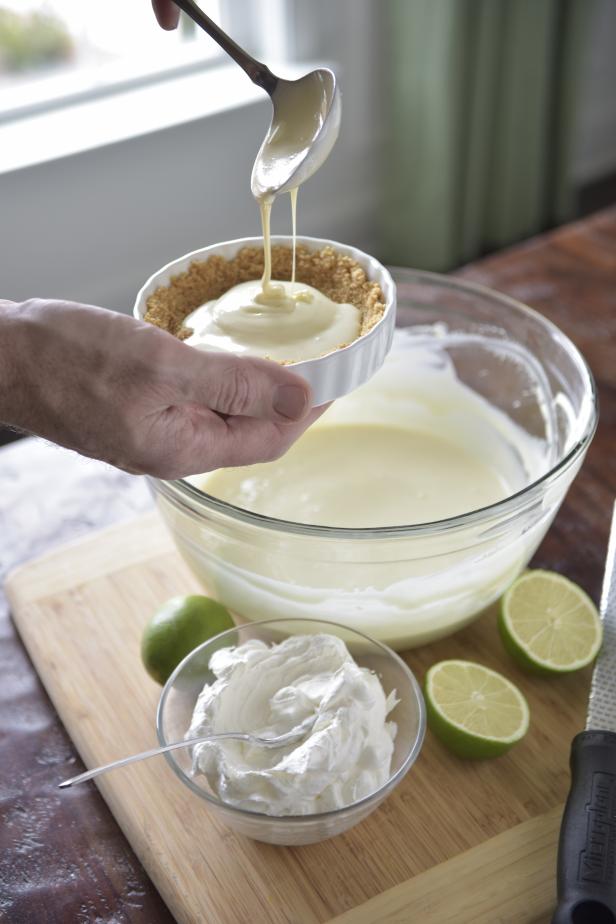 Spoon the filling into the four ramekins, leaving a ¼ inch border of graham cracker crust at the top of each dish.