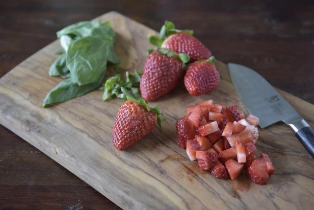 Wash and hull the strawberries. Crush them and strain the liquid into a cocktail glass.