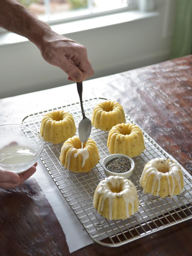 Use a small spoon to drizzle glaze from the small bowl and onto the cooled cakes.