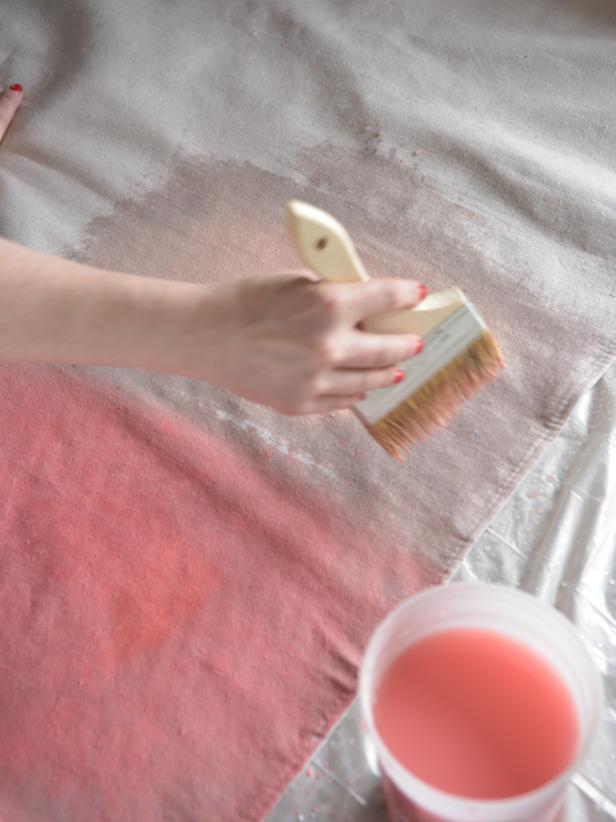 Dip the chip brush into one color of paint and loosely brush it over the wet rectangular area. The paint will spread and begin to bleed, taking on a watercolor look.