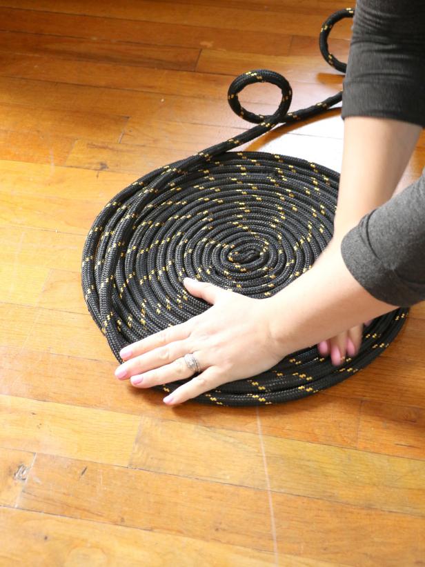 Coil the rope until the rug is approximately 24â across. Hold the coil down with your hands so it doesnât unravel.