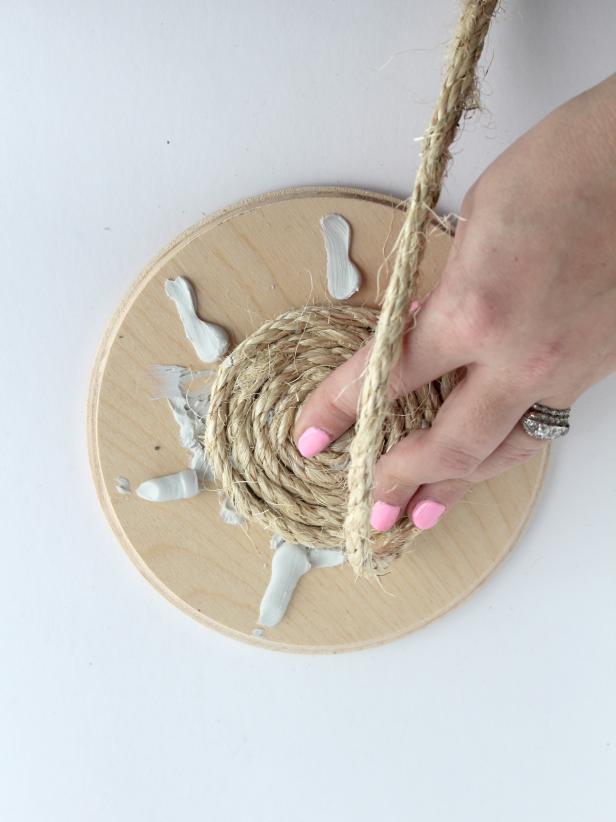 Continue to glue and wrap until the entire wooden circle is covered in rope.
