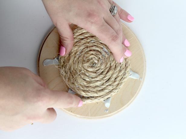 Continue to glue and wrap until the entire wooden circle is covered in rope.