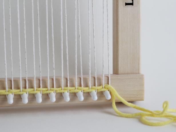 Continue to create sheds, thread the yarns through, and pushing down with your fingers until you create your first stripe. Make it as wide as you like.