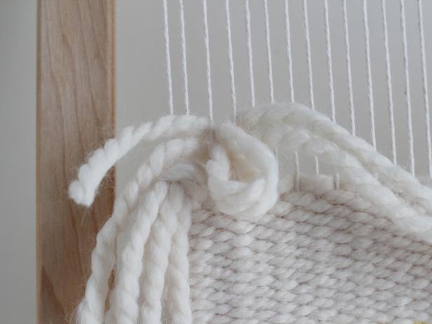 Pull the ends of the yarn through the loop and pull down.
