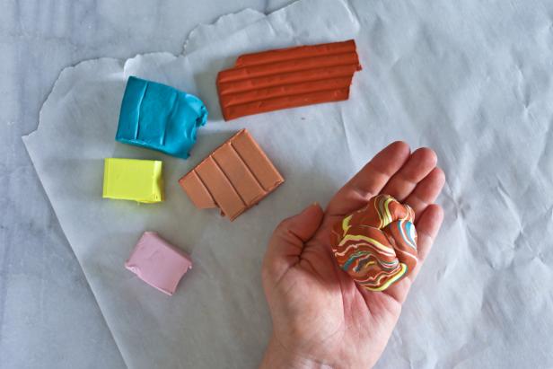 Make Mom a clay jewelry dish this Mother's Day. The turquoise and gold marbled accent colors add glamour to the terra cotta-colored dish.