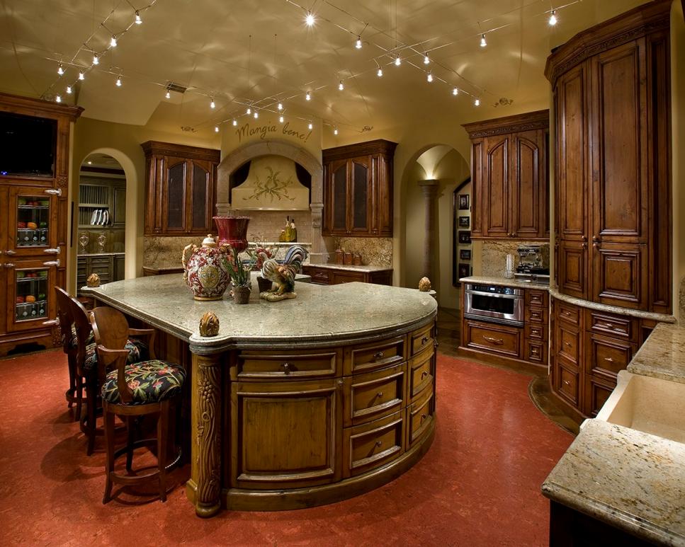 Spacious Kitchen Boasts Twinkly Track Lighting Kitchen With Wood Cabinets, Large Island and Red Flooring