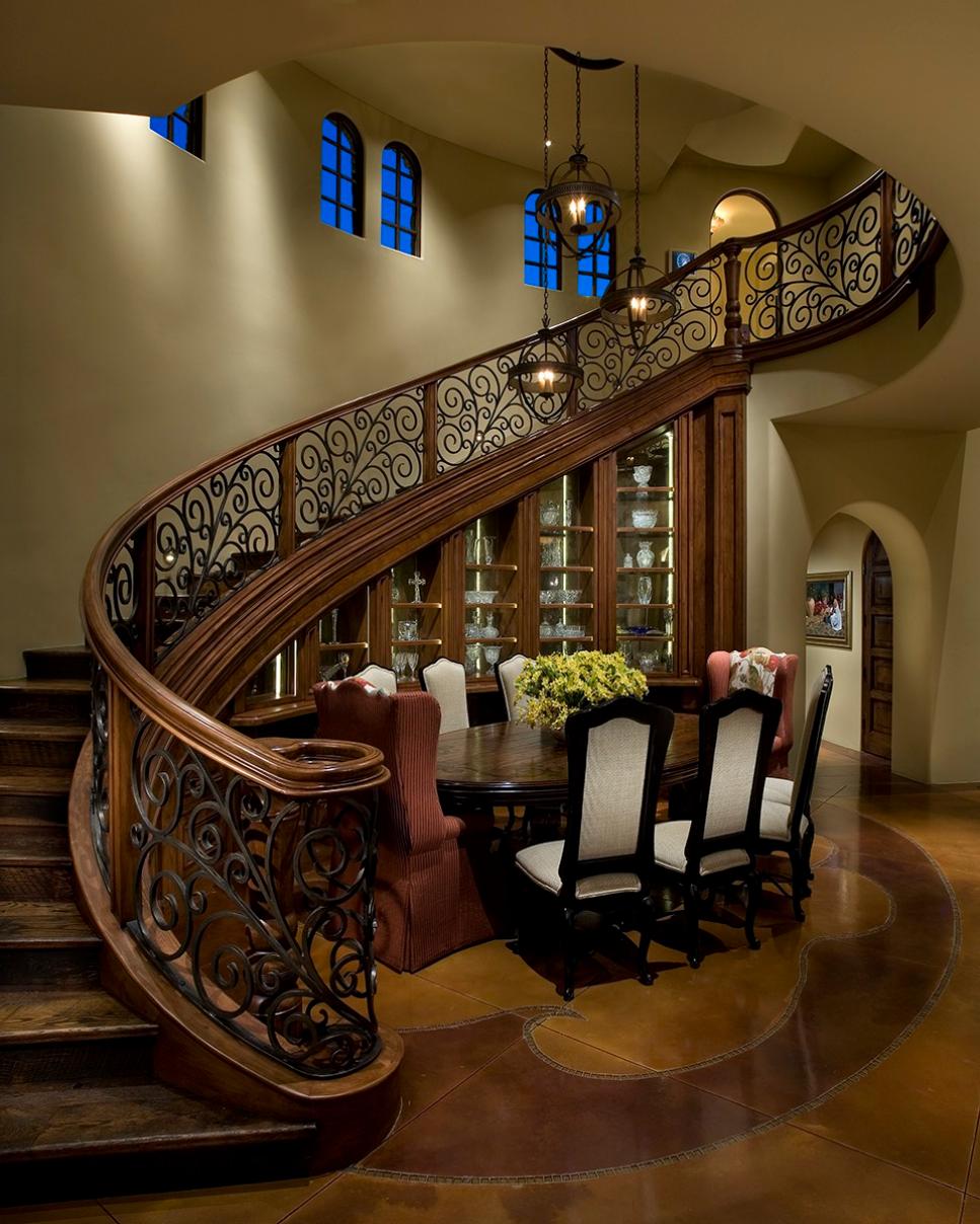 Curved Staircase Wraps Around Mediterranean Dining Room Wood Staircase With Wrought Iron Railing in Mediterranean Dining Room