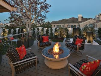 Neutral Contemporary Porch With Round Fire Pit and Metal Armchairs