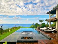 Wood Deck Surrounds Infinity Pool With Oceanfront View