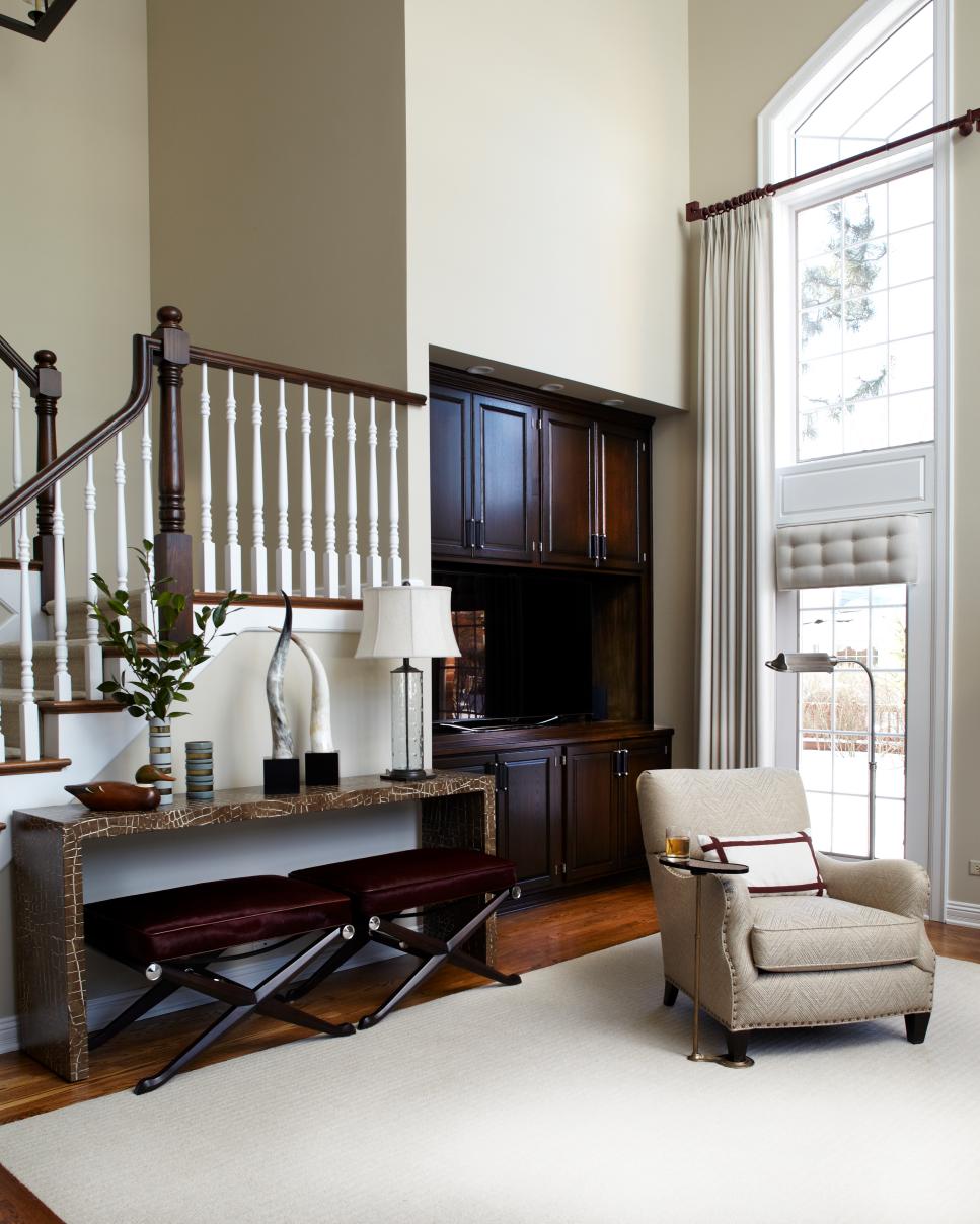 Transitional Great Room Features Built-In Wet Bar for Entertaining Corner of Great Room and Staircase in Brown and Neutral Tones