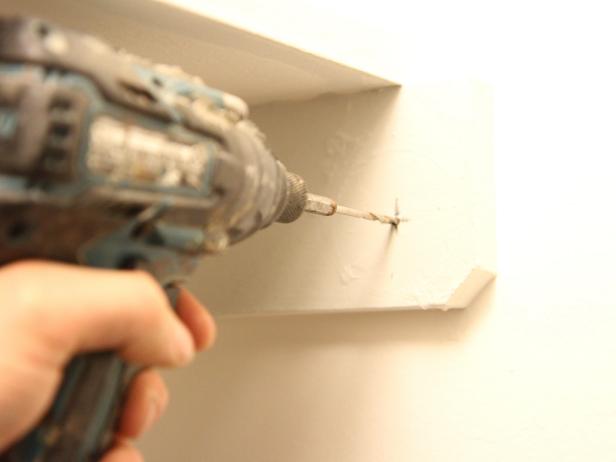 Pre-drill a hole for the bracket screw using a quarter inch drill bit.