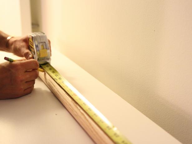 Measure and mark the closet rod at desired measurement with a pencil.