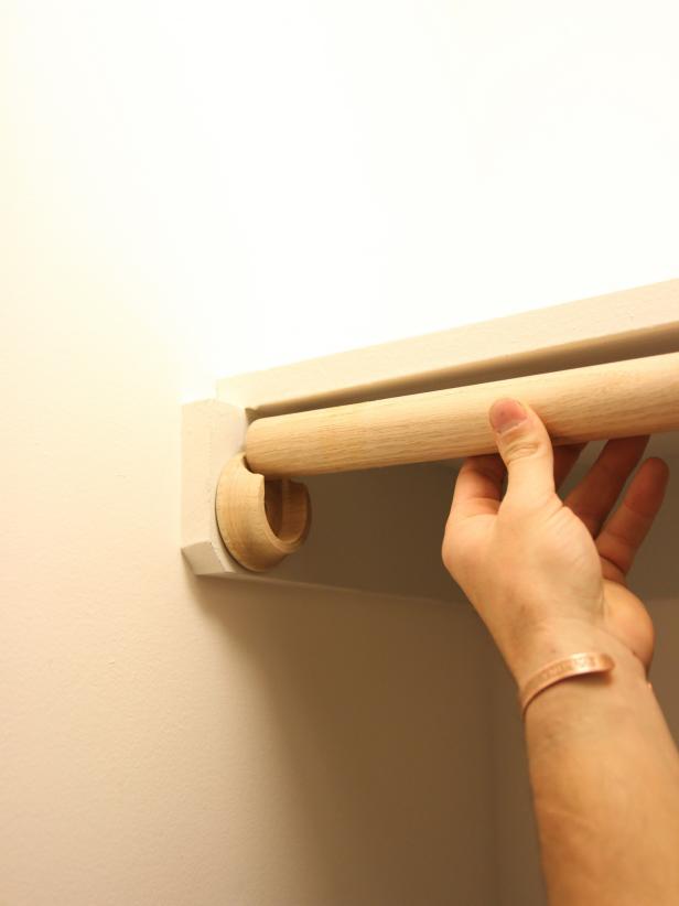 Slide the rod into the left side u-shaped bracket