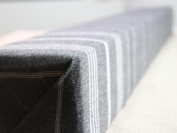 Finish the fabric on the corners by folding a hospital corner. Wrap and staple on the interior of the cornice.