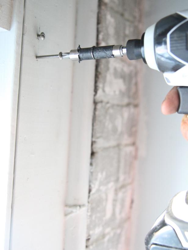 Drill the screws into the pre-drilled holes, stopping about ¼â away from the face of the window frame.