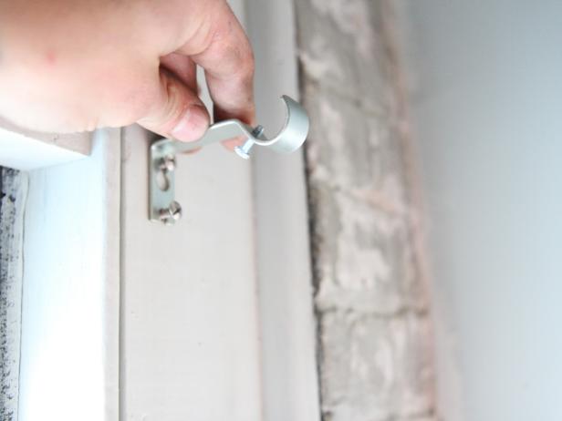Slide the bracket onto the screws.