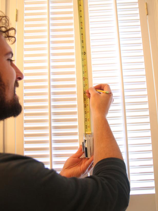 Layout the hardware for the shutters by making a pencil mark half-way down on the face of the shutter doors.