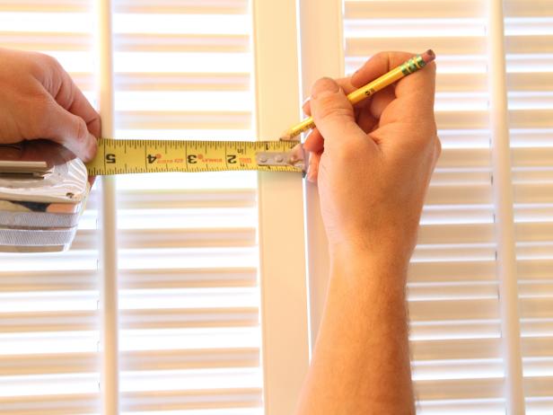 Measure for center on each door frame and make a vertical mark that intersects with the horizontal line.