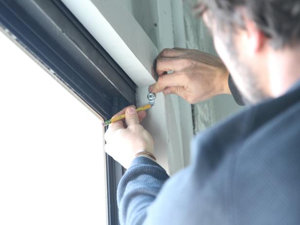 Using the center mark as a guide, mark the holes for the shade hardware.