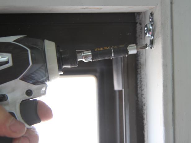 Secure the hardware to the window frame using the screws provided with the hardware