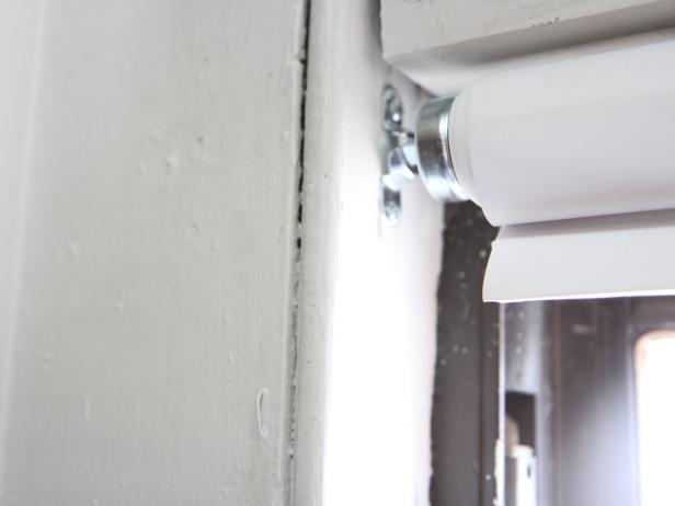 Hang the shade by sliding the appropriate ends into the secured hardware brackets.