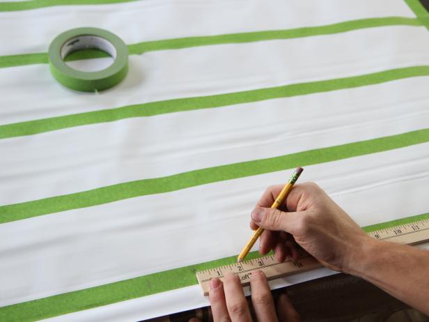 Measure 2â from one side of center and make a mark. Repeat steps at the center and top of the shade.