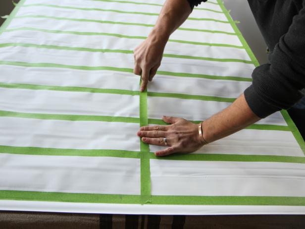 Run a vertical tape line, based on the mark 2â off of center, the entire vertical length of the shade.