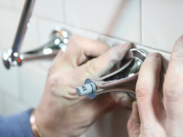 Slide the left side accessory with the pivoting arm on first and then secure the right side accessory by pushing flush against the wall and then down onto the mounting bracket