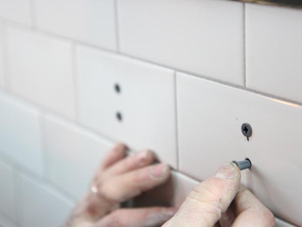 Insert plastic anchors provided with the toilet paper holder.