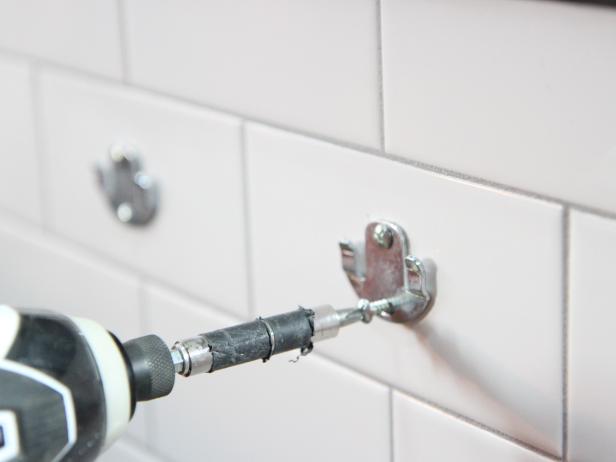 Secure mounting plates to the wall using screws provided.