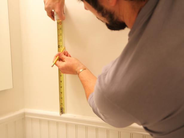 Measure the desired height on the wall where the towel rack will hang
