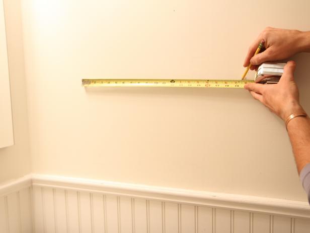 Using the measurement from step 1, make two small vertical marks on the wall to determine the exact spacing and layout of the rack.