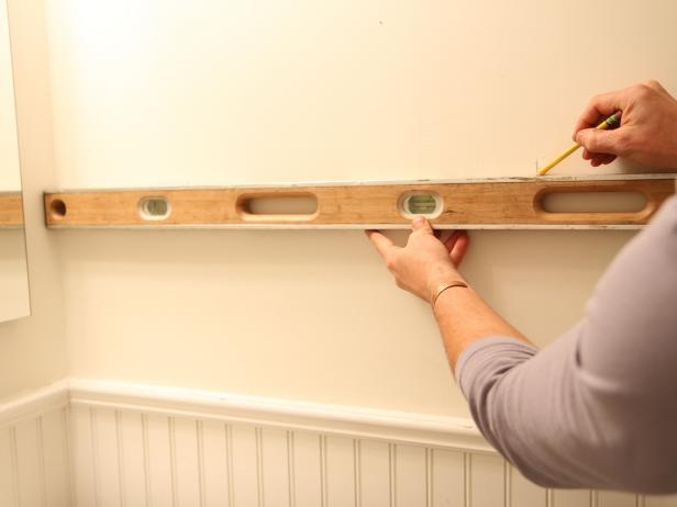 Use a level to make two horizontal marks with a pencil that intersect with the vertical marks from step 3, creating a â+â sign.