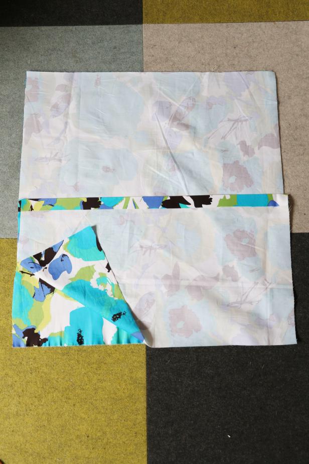 Place the square face up on the table. Put one rectangle face down over the square with the folded edge in the center of the square and the left edges lined up. Put the other rectangle face down over the first with the folded edge in the middle of the square and the right edge lined up with the right edge of the square.