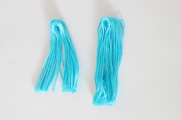 Cut the whole skein of embroidery floss in half.