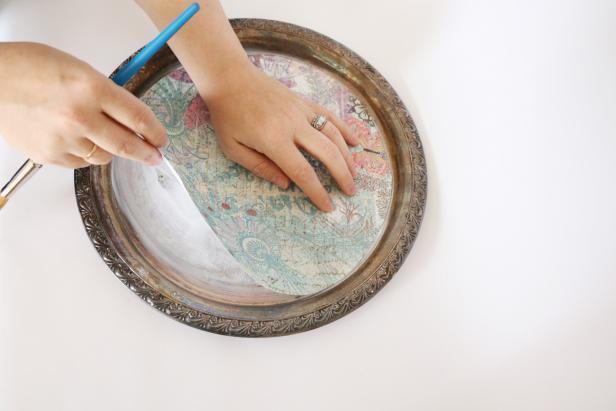 Place the paper on the mod podge, smoothing out any bubbles.