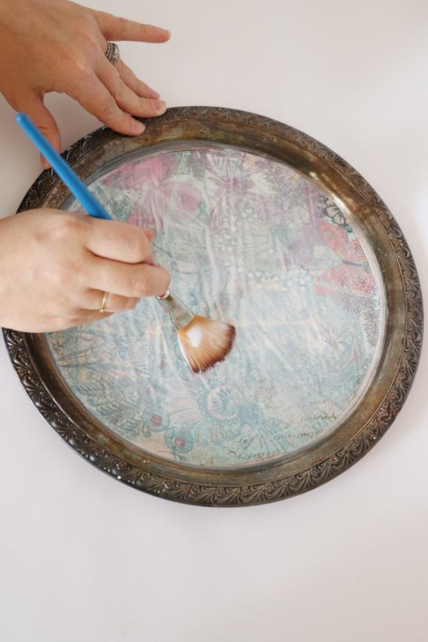 Pour another small pile of mod podge on top of the paper. Brush it into an even and smooth layer over the paper. Let dry.