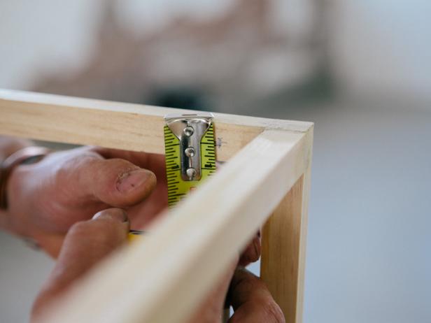 Measure down ½” inch on the inside of the top square and make two marks about an inch from the corner on opposite sides of the frame where the shelf pegs will go.