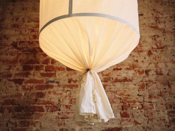 Make an oversized pendant light with aluminum bars and a flat sheet.