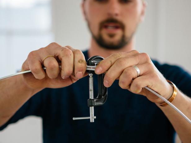 Overlap the two ends of the flat bar to the edge of the 2” mark, and clamp the ends together tightly using a C-clamp.