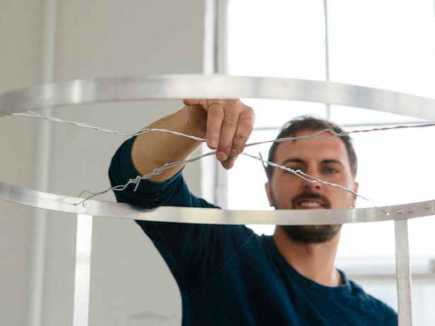 Loop 18-guage wire through the four holes, creating an X at the top of the frame.