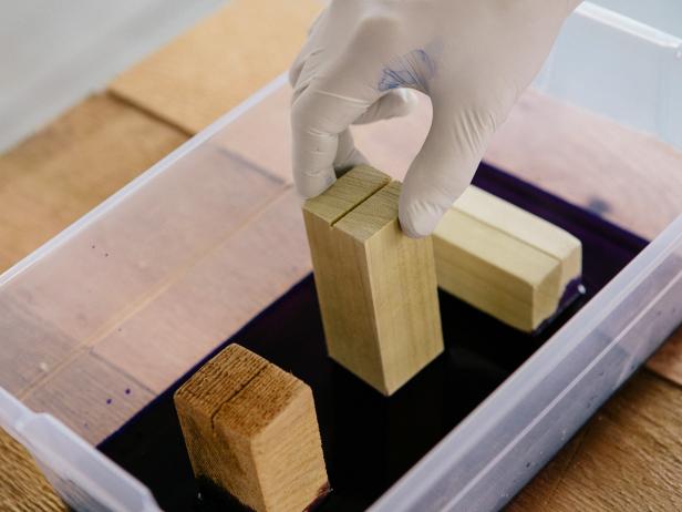 Place wood blocks in dye to create color-blocked photo holders.