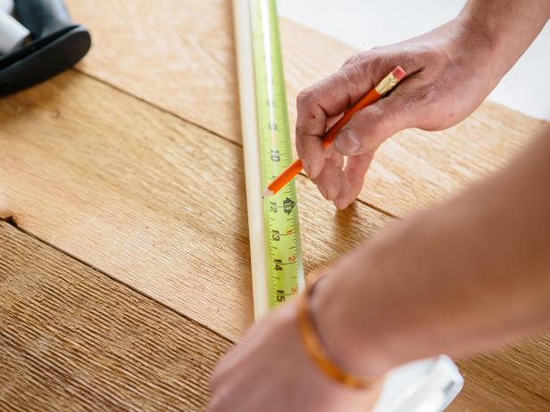 Measure wood dowels to make a coffee table.