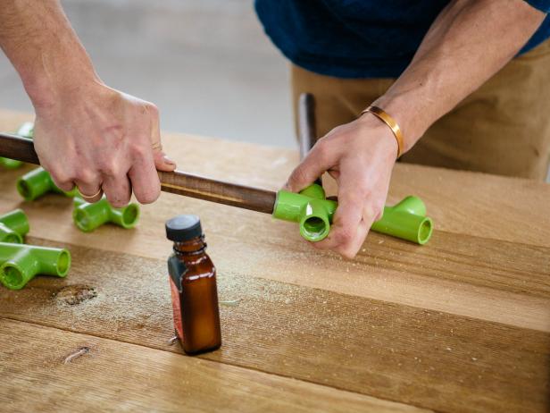Apply contact cement to wood dowel, and insert into PVC piping to make a coffee table.